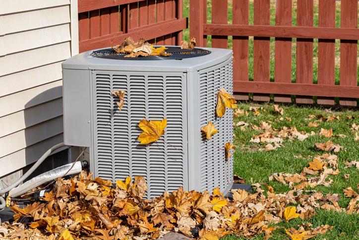 hvac covered in fall leaves